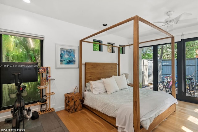 bedroom with access to outside, light hardwood / wood-style flooring, and ceiling fan