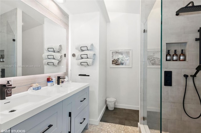 bathroom featuring walk in shower, tile patterned flooring, and vanity