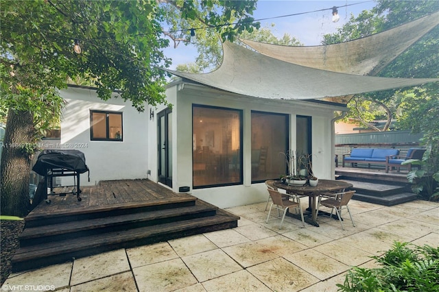 back of house with a deck and a patio area