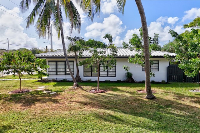 rear view of property featuring a yard