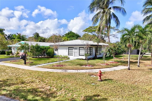 ranch-style home featuring a front yard