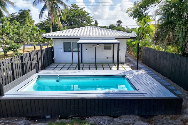 view of swimming pool featuring ceiling fan