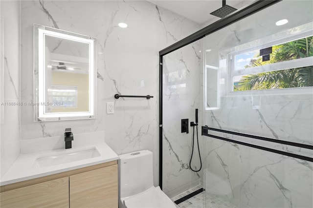 bathroom featuring an enclosed shower, vanity, and toilet