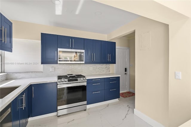 kitchen featuring decorative backsplash, appliances with stainless steel finishes, sink, and blue cabinets