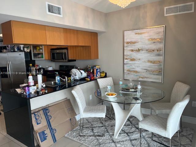 kitchen with stainless steel appliances and light tile patterned floors