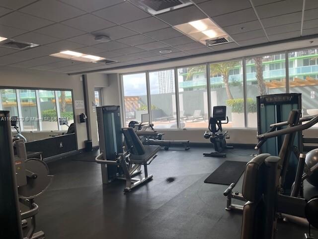 workout area featuring a paneled ceiling