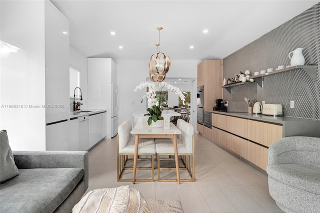 dining space with sink and a chandelier