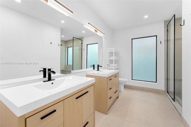 bathroom featuring toilet, an enclosed shower, and vanity