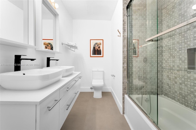 full bathroom featuring shower / bath combination with glass door, toilet, and vanity