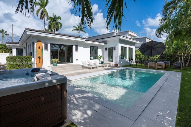 view of swimming pool with a hot tub and a patio