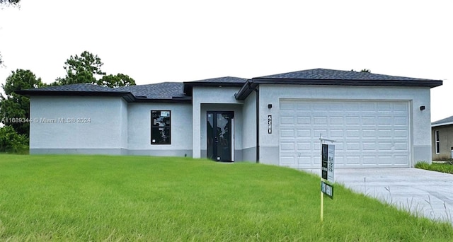 view of front facade with a front lawn and a garage