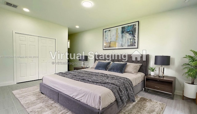 bedroom featuring light hardwood / wood-style flooring and a closet