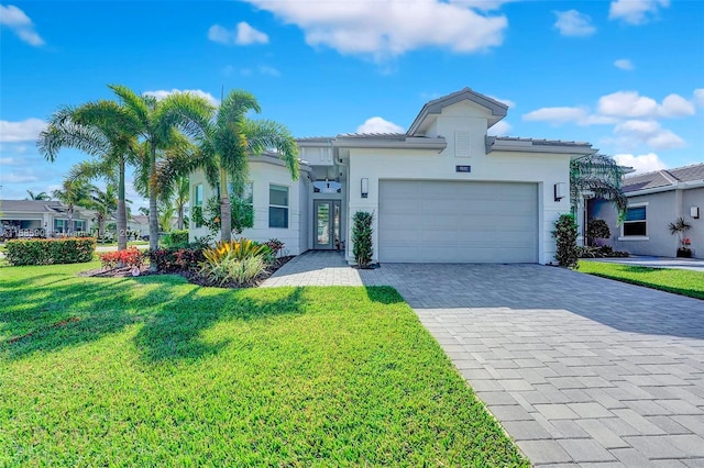 view of front of property featuring a garage and a front yard