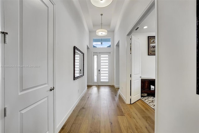 hallway with light hardwood / wood-style floors