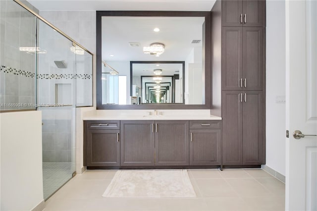 bathroom featuring vanity, tile patterned floors, and a shower with shower door