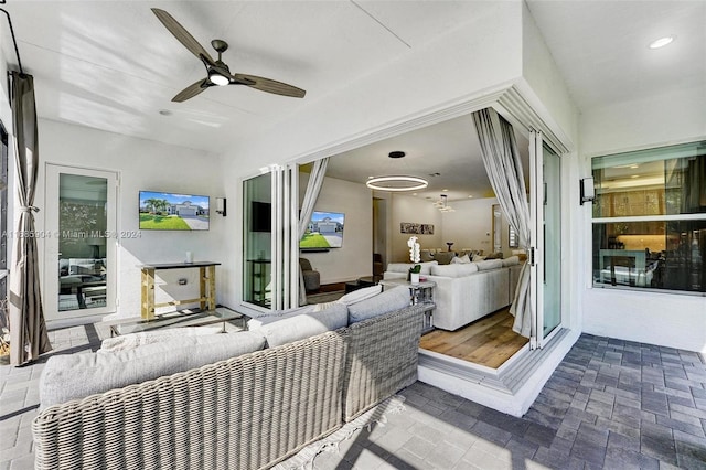 interior space with ceiling fan and an outdoor hangout area