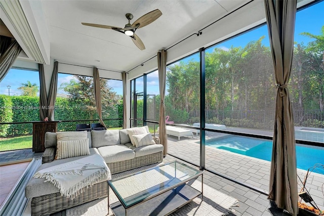 unfurnished sunroom with a wealth of natural light and ceiling fan