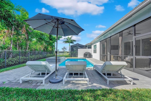 view of swimming pool with a sunroom and a patio