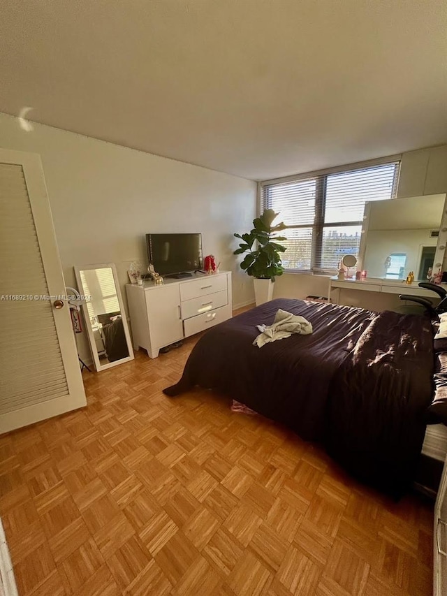 bedroom with light parquet flooring