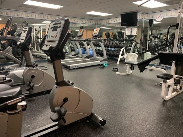 workout area with a paneled ceiling