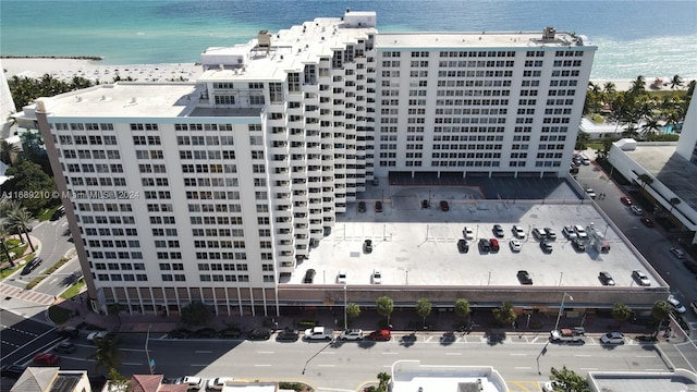 drone / aerial view featuring a beach view and a water view