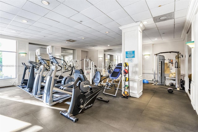 workout area featuring a paneled ceiling and ornate columns