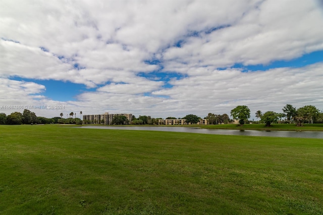 view of community featuring a yard and a water view