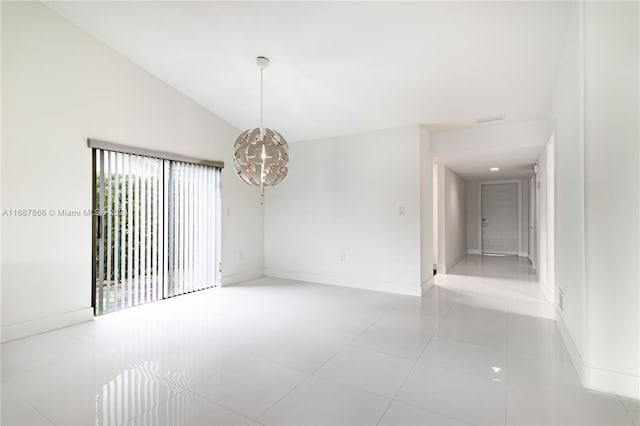 unfurnished room with lofted ceiling, light tile patterned floors, and an inviting chandelier