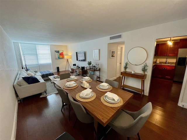 dining room with sink and dark hardwood / wood-style flooring