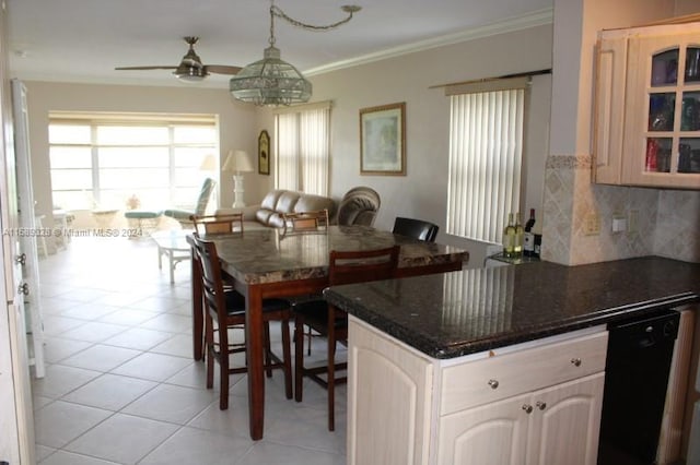 tiled dining room featuring ornamental molding and ceiling fan with notable chandelier