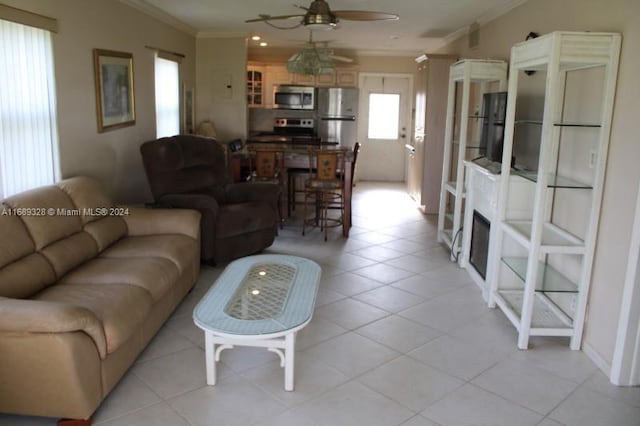 tiled living room featuring ceiling fan and ornamental molding