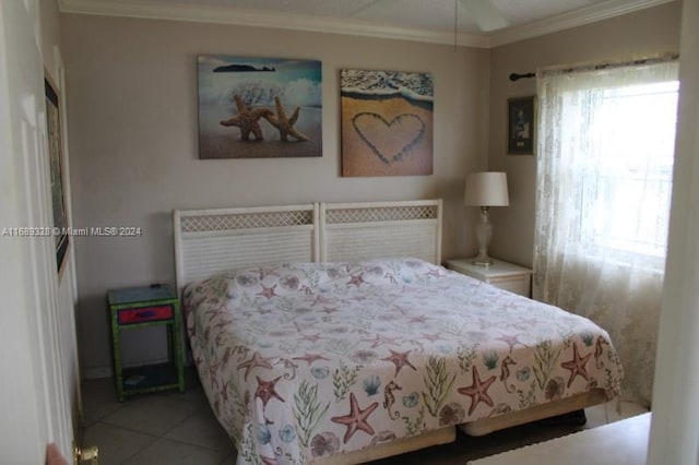 tiled bedroom with ceiling fan and crown molding