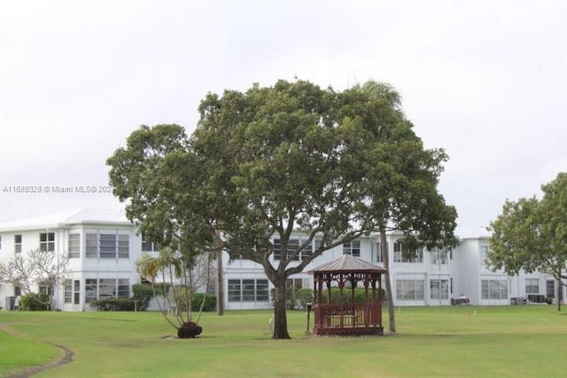 view of property's community with a yard and a gazebo