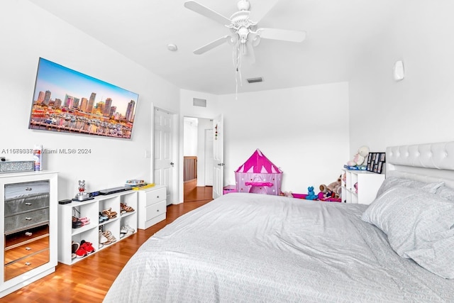 bedroom with wood-type flooring and ceiling fan