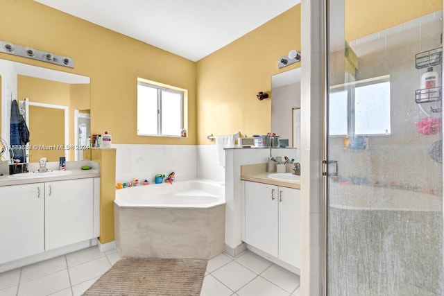 bathroom with tile patterned flooring, vanity, and plus walk in shower