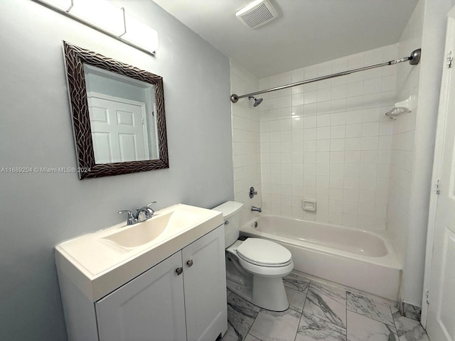 full bathroom featuring tiled shower / bath, vanity, and toilet