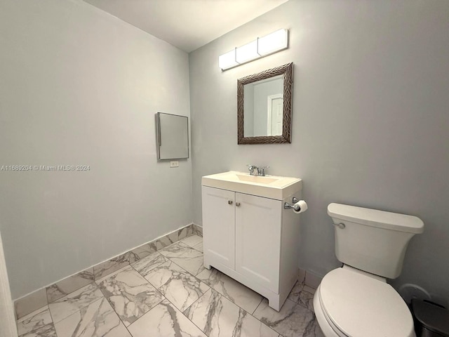 bathroom with toilet and vanity