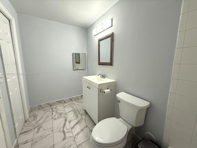 bathroom featuring toilet and vanity