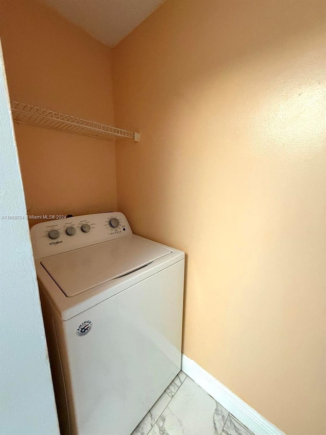 clothes washing area featuring washer / dryer