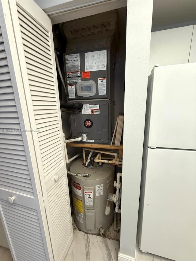 utility room featuring water heater