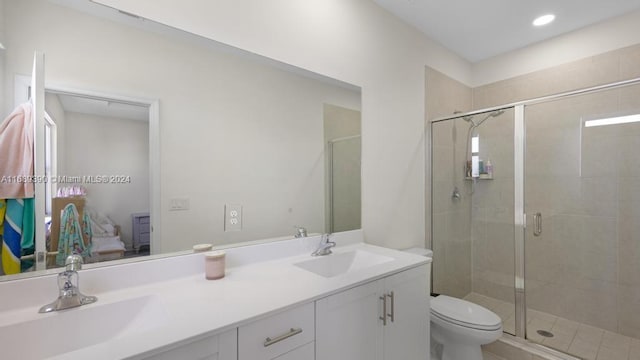 bathroom featuring vanity, toilet, and an enclosed shower