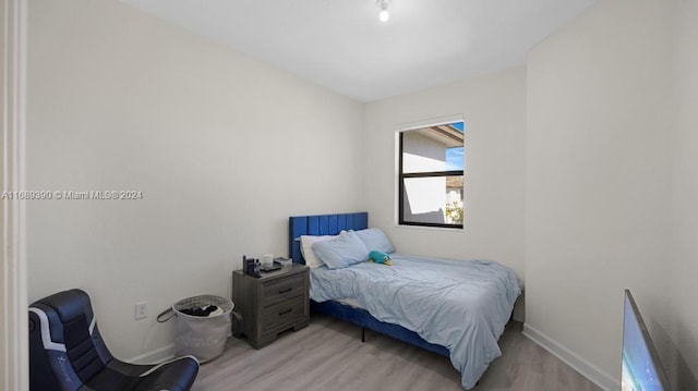 bedroom with light wood-type flooring