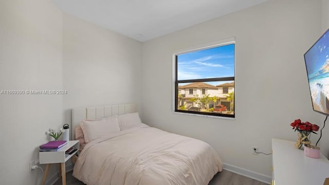 bedroom with hardwood / wood-style flooring