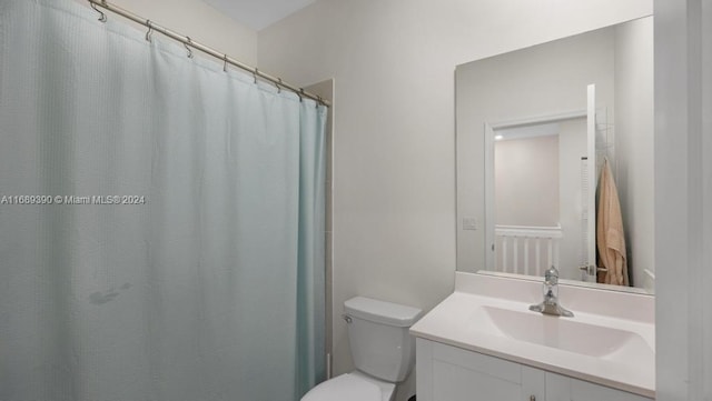 bathroom with vanity, toilet, and walk in shower