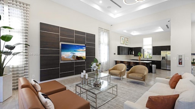 living room with a raised ceiling and a towering ceiling