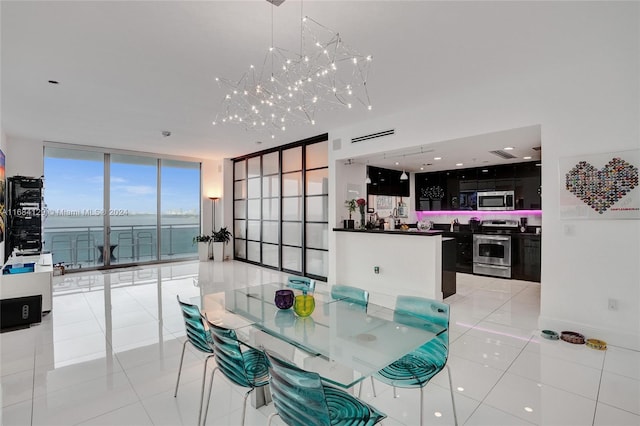 tiled dining room with a wall of windows, a water view, and a notable chandelier