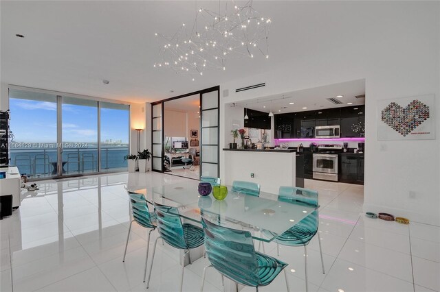 dining area with a wall of windows, light tile patterned floors, and an inviting chandelier