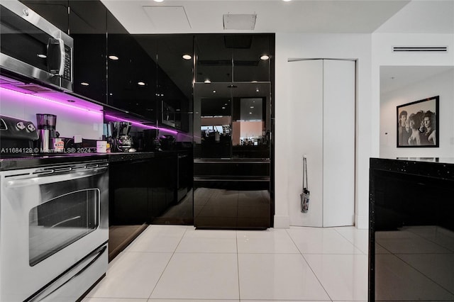 kitchen featuring light tile patterned floors and stainless steel appliances