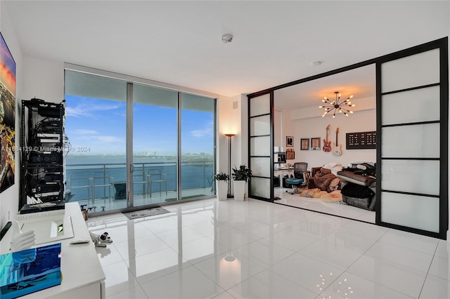 interior space featuring a wall of windows, a chandelier, and a water view