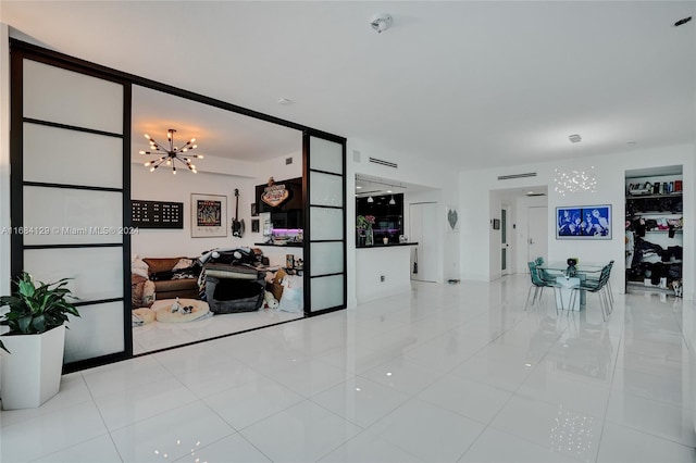 living room featuring an inviting chandelier and light tile patterned flooring